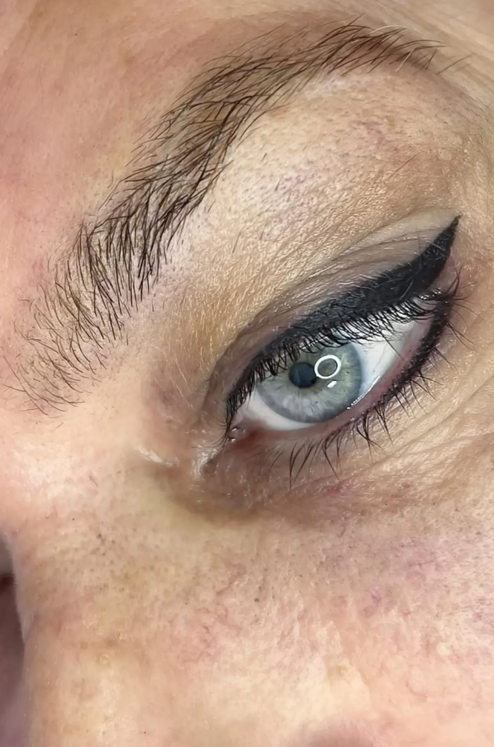 winged eyeliner tattoo